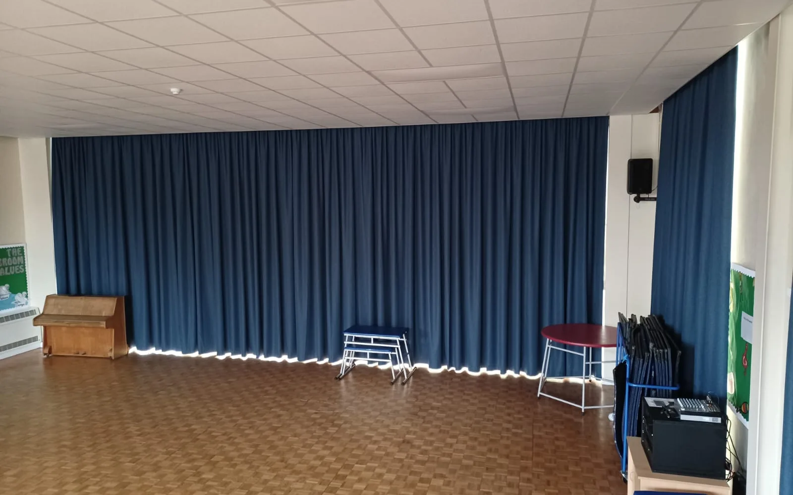 Heavy-duty blackout curtains for a school hall